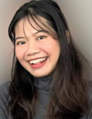 A person smiling for the camera  Description automatically generated with low confidence